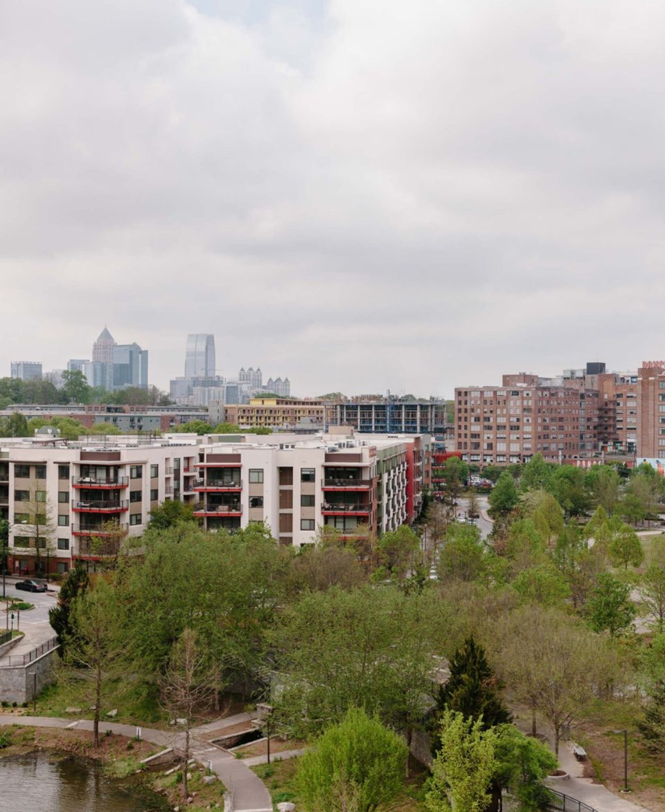 Overline Residences' tree-lined neighborhood with Atlanta skyline & buildings
